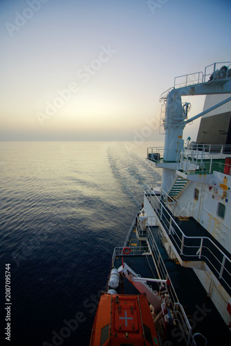 View of the stern of a merchant ship at sea in the morning