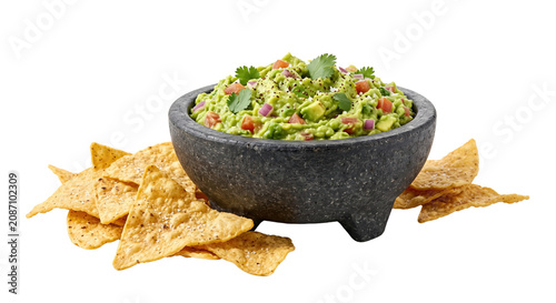 Bild auf Leinwand Fresh guacamole dip in stone molcajete with tortilla chips