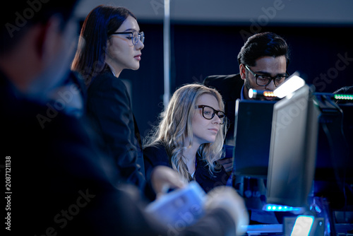 Fotografie Building tomorrow AI tonight deep focus diverse engineers code train complex models multi screen setup innovation lab intense collaboration future tech taking shape now project crunch