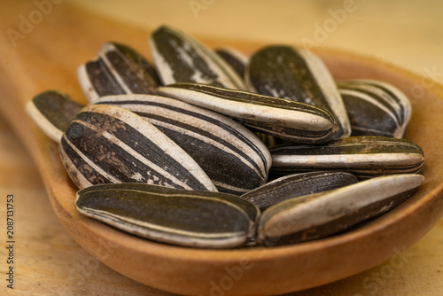 Sunflower seeds in a wooden bowl.