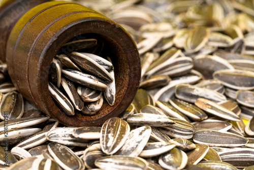 Sunflower seeds in a wooden bowl.