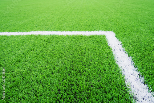 Football field corner marking artificial turf soccer field white line creating clean sports background with vivid green synthetic grass