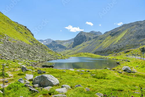 Alpine lake beside a mountain pass road in summer