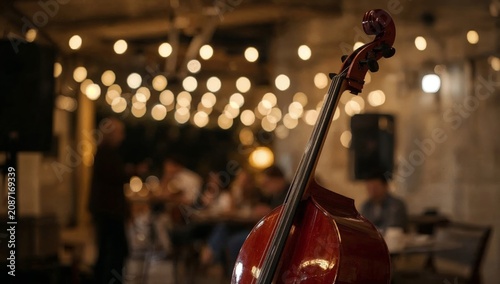 Live Music Performance With Cello in a Dining Area With Warm Lights in the Ev...