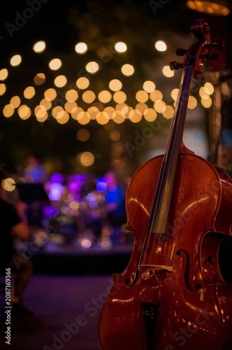 Live Music Performance With Cello in a Dining Area With Warm Lights in the Ev...
