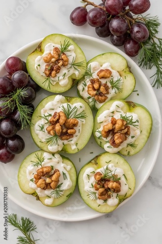 Fruit Platter With Green Apples, Walnuts, and Grapes on a White Plate