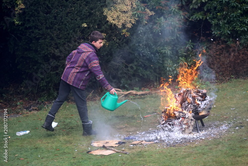 A young man is holding a box that is on fire