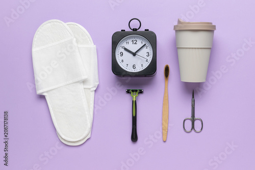 Obraz na plátně Morning Routine Essentials on Purple Background with Coffee Cup, Clock, and Hygi