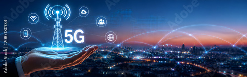 5G network tower with connected icons over city skyline