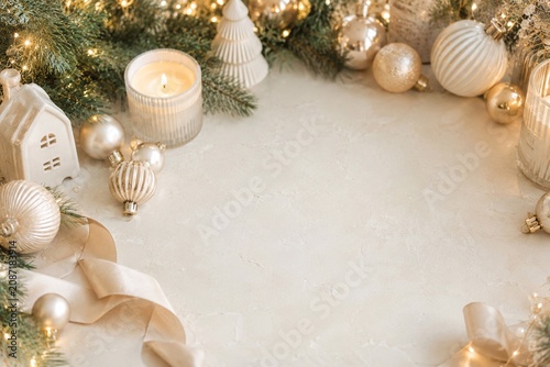 Elegant Christmas Ornaments With Candle and Evergreen Soft holiday flat lay with gold and white ornaments, candlelight, evergreen branches, ribbon, and blank copy space