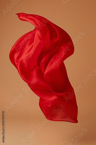 Flowing Red Fabric Moving in the Air Against a Light Background