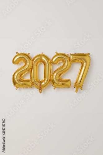 Gold Balloons Showing the Number 2027 on a Plain Background