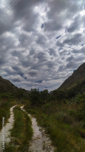 A breathtaking mountain landscape with cascading waterfalls in the Espinhaço Mountain Range, Minas Gerais, Brazil.