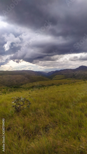 A breathtaking mountain landscape with cascading waterfalls in the Espinhaço Mountain Range, Minas Gerais, Brazil.
