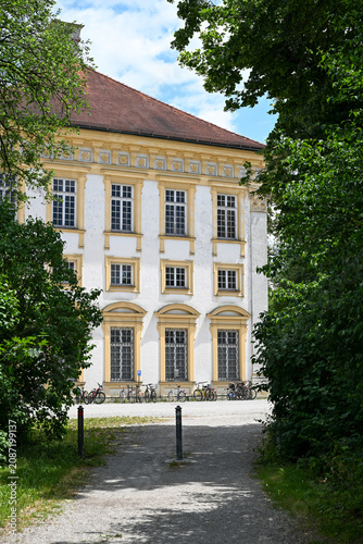 Historic building facade framed by trees and bicycles