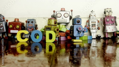 Vintage robots make the word coding with wooden letters stop motion 