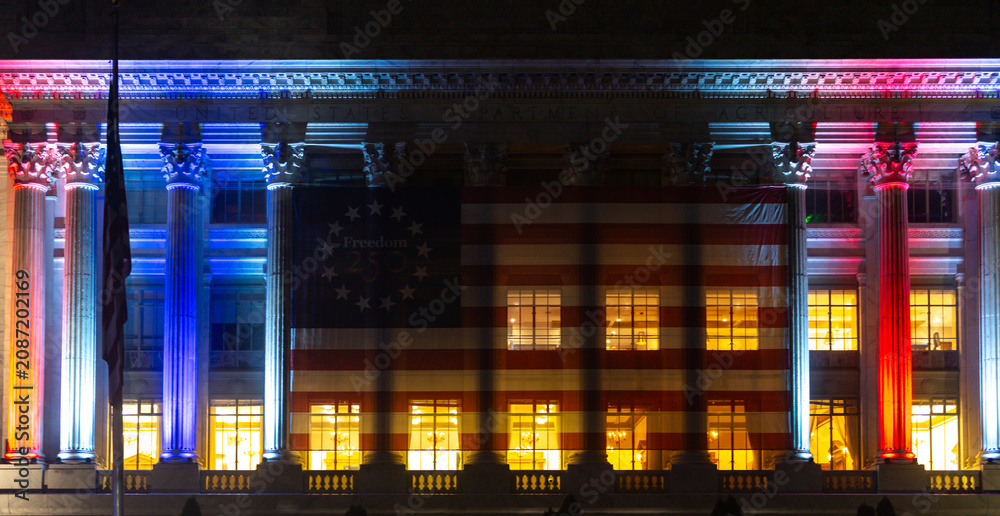 Obraz premium USA patriotic lights on architecture. USA flag decorates federal department. Independence banner honors USA history. Night exterior shows USA celebration.