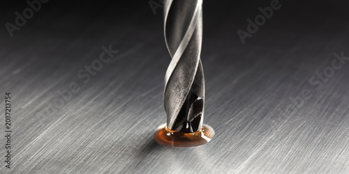 Bild auf Leinwand drill bit with technical lubricant make hole in metal aluminum plate