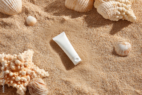 Blank White Sunscreen Tube Mockup Styled with Seashells and Starfish on Sandy Beach, Flat Lay