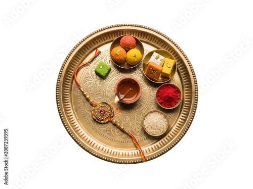 Traditional brass thali with rakhi and sweets isolated on transparent