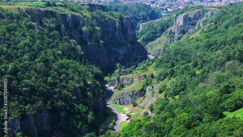 Tracking telephoto aerial shot of Cheddar Gorge in Somerset, UK