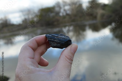 hand holding a black tourmaline 
