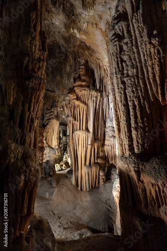 Brown cave interior with stalactites and stalagmites natural rock formations