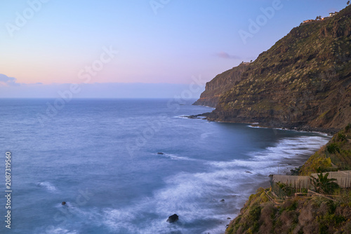 El Ancon Beach, with its black sand, large rocks, and the Atlantic Ocean, in Tenerife, Spain long exposure at sunset