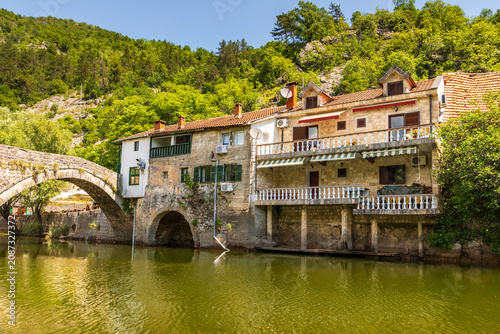 Rijeka Crnojevica village architecture by green river Montenegro