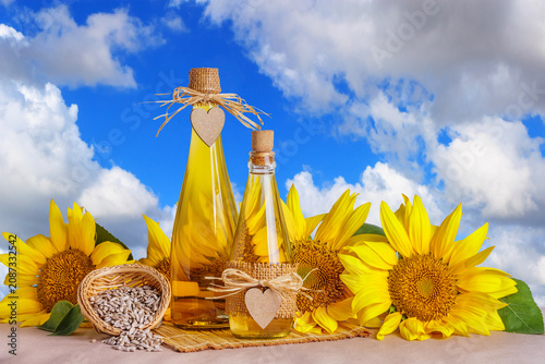 Fotografie Rural still-life - sunflower oil in glass bottles against the background of the