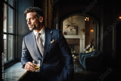 Elegant man with a haughty demeanor exuding elitism in a sophisticated setting