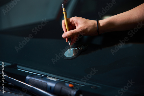 Photos Technician uses precision scriber to clean glass damage point