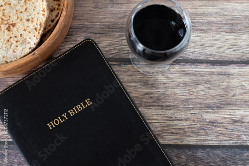 Photos Holy bible, unleavened bread and glass of wine on a wooden background