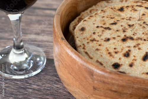 Tableau sur toile Unleavened bread and wine on a wooden table