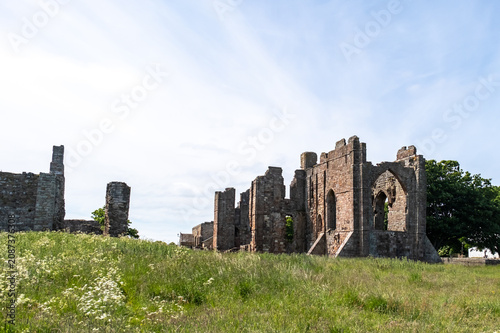 Ancient abbey ruins glow in warm sunlight, their weathered stonework and historic arches standing as a timeless reminder of centuries past