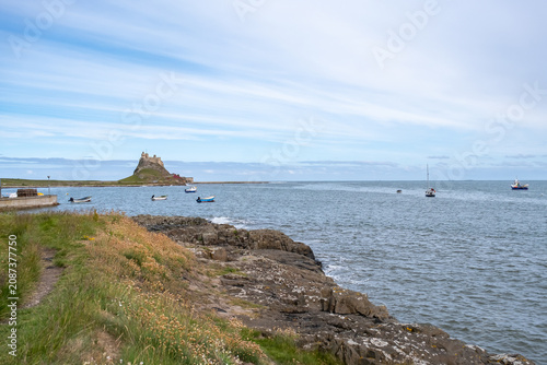 A sweeping view across the beach and bay on Holy Island, Northumberland coast, capturing the wide shoreline and tranquil waters under an open coastal sky.