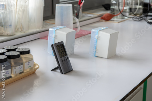 Cuadro en lienzo Laboratory sample bottles with soil samples, digital thermometer and laboratory
