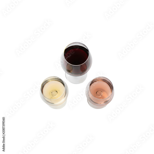 Three pristine crystal wine glasses filled with deep ruby-red, pale straw-gold white, and light salmon-pink rosé wines, flat lay on a transparent background. Concept of elegant wine selection