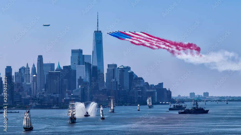 Fototapeta premium Celebrate July 4th and the 250th anniversary of the USA with iconic fireworks and aerial displays over the New York skyline featuring ships and a blimp in a vibrant festive atmosphere.