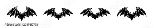 фотографія Four black bat wing silhouettes arranged in a row on a white background