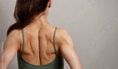 Bild auf Leinwand Rear view of a fit young woman showing toned back muscles, shoulder blades and healthy posture