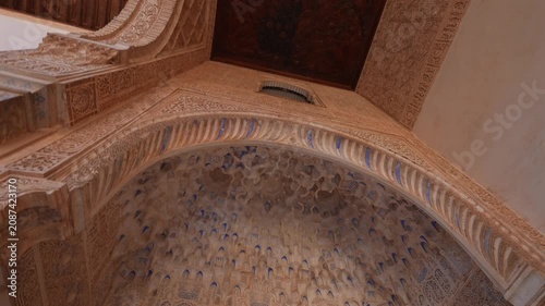 Decorated Carved Arch in Alhambra, Granada. Wall details and Magnificent moorish interior in Alhambra palace, Granada.