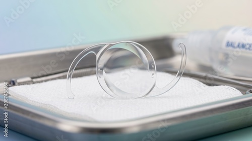 Toric intraocular lens for astigmatism correction on sterile gauze. Close up of ophthalmic IOL implant in surgical tray