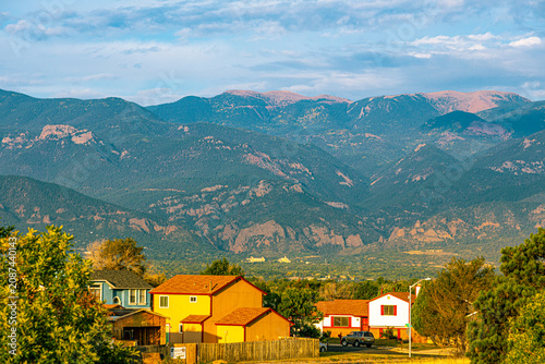 Suburban houses in Colorado Springs with the massive Front Range mountains rising in the background.