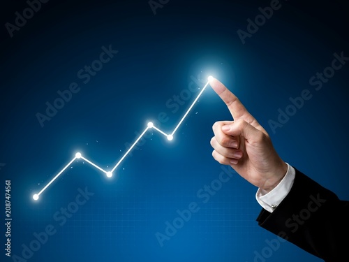 Hand Pointing At Rising Financial Growth Chart With Digital Business Analytics And Market Success