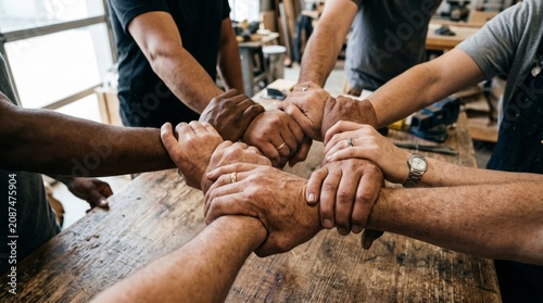 Close Up of Team Holding Wrists Together in Union