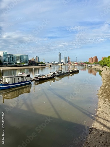 Chelsea Embankment London, house boats in the River Thames with residential buildings in the background. Taken on a sunny morning.  Copy Space No people
