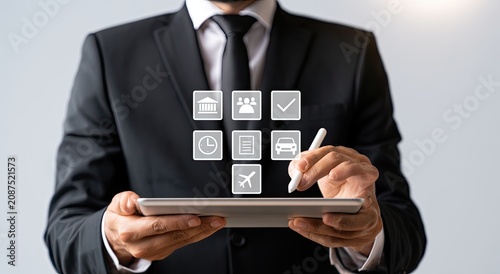 Man in suit selects options on a digital tablet displaying service icons