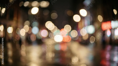 Urban night scene with blurred city lights and bokeh effect showcasing vibrant evening atmosphere.