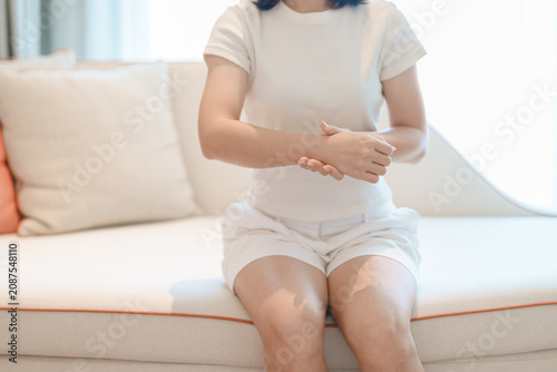 Woman having wrist pain for Carpal Tunnel Syndrome, Wrist Tendinitis, muscle ache, De Quervain s tenosynovitis, ergonomic, Hand Osteoarthritis, Office syndrome and Parkinson disease concept